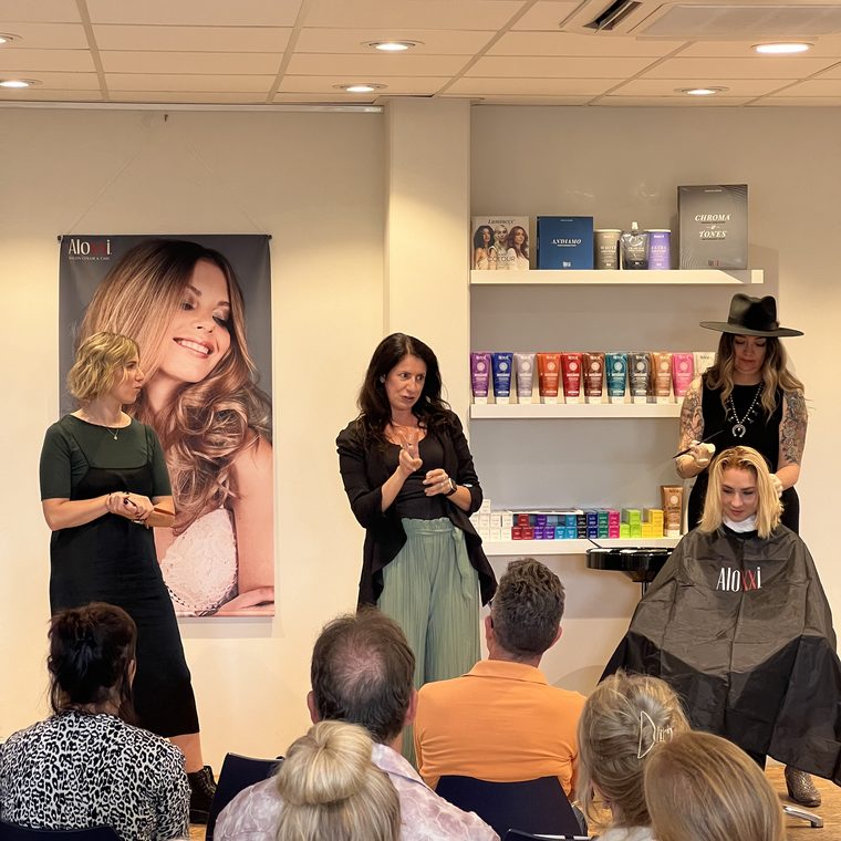 Jessica leading a class in a salon abroad