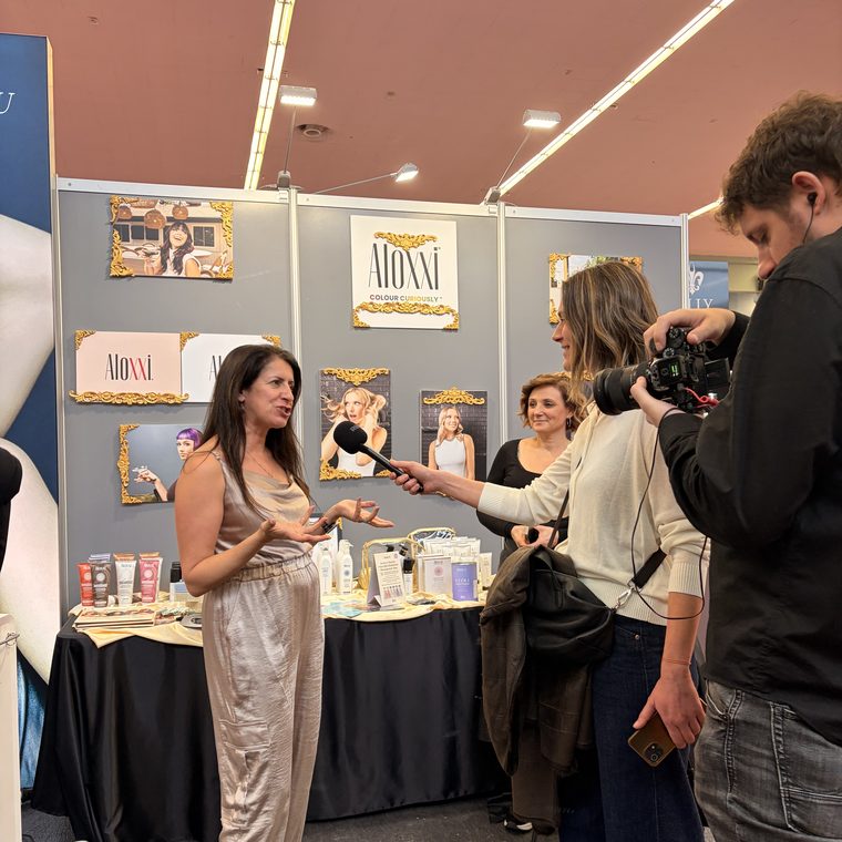Jessica being interviewed at a trade show