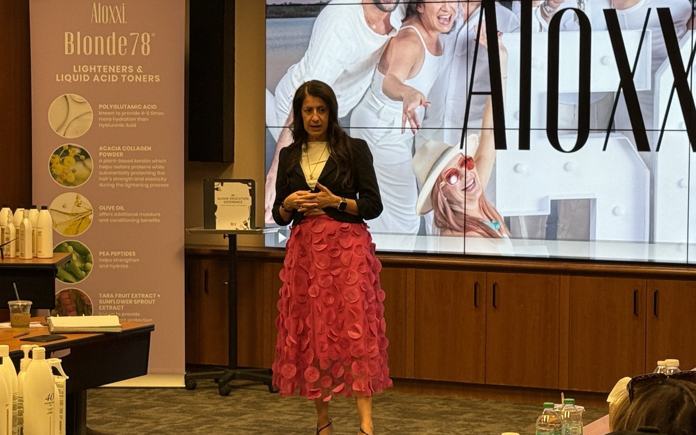 Jessica presenting on stage at a brand education event